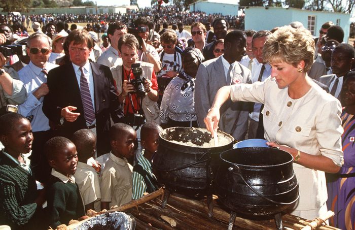 Princess Diana at the Nemazura feeding centre - a Red Cross project for refugees in Zimbabwe, July 1993. She is wearing a safari suit by Catherine Walker.