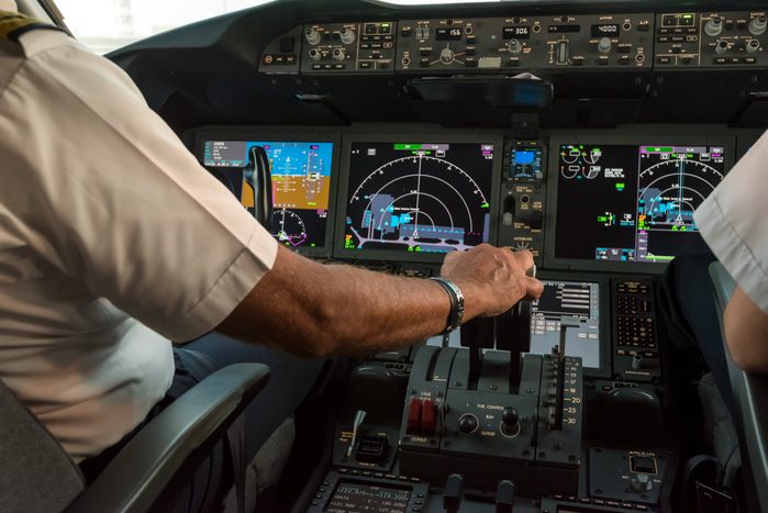 Modern commercial jet aircraft cockpit and pilots