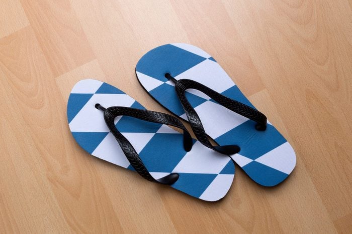overhead view of a pair of flip flops on a wood floor