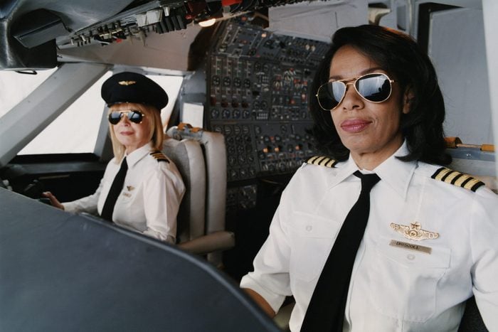 Portrait of Female Pilots Sitting at the Cockpit