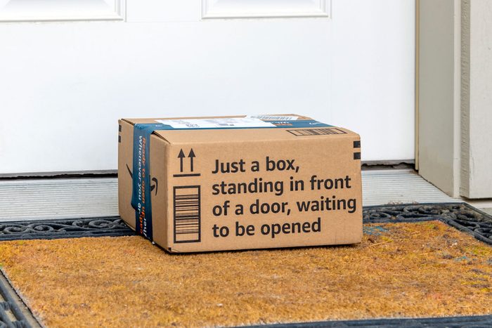 Amazon Prime Shipped Cardboard Box Package With "just A Box, Standing In Front Of A Door Waiting To Be Opened" On The Doorstep Of A Suburban Home In Spokane, Washington
