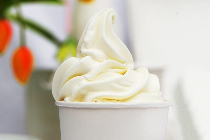 close up of vanilla frozen yogurt swirl in a paper cup