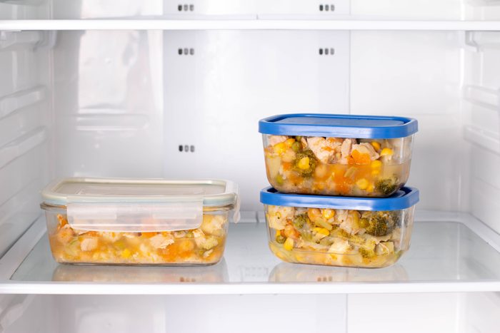 Frozen food in a container in the freezer. Ready meal. Refrigerator with frozen food.