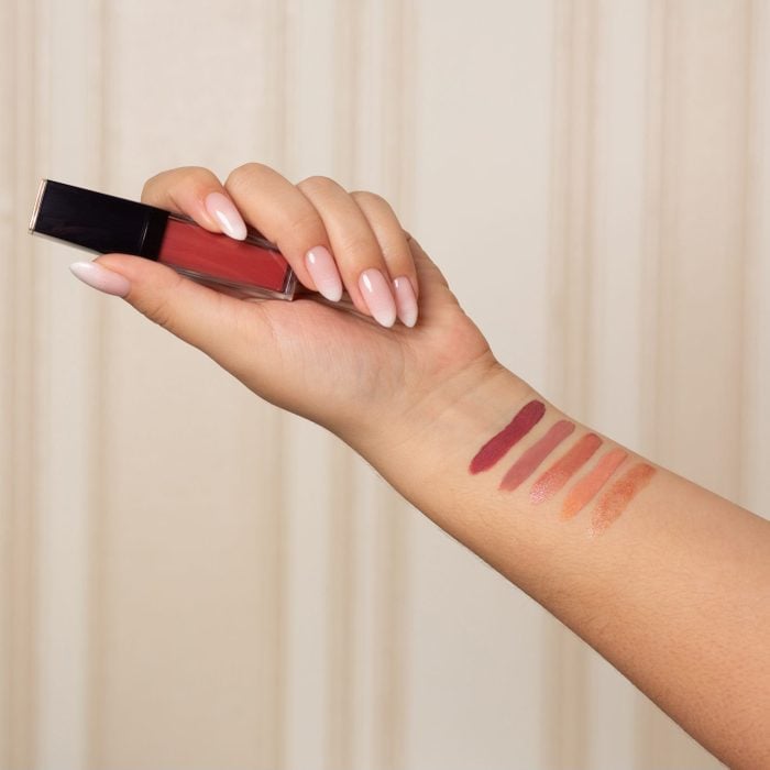 Female hand with swatches of liquid lipstick