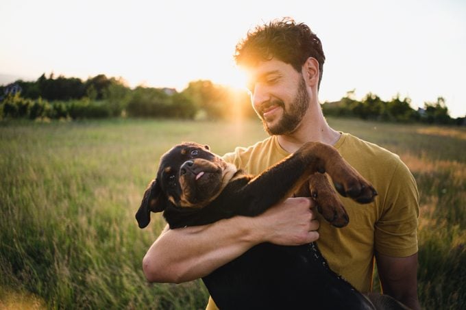 Man holding a Rottweiler puppy dog