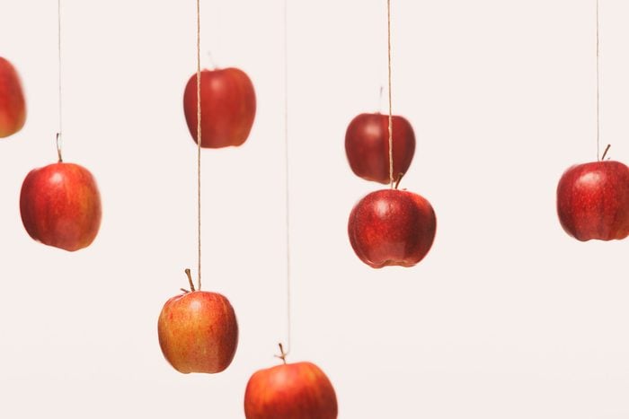 red Apples Hanging On Strings