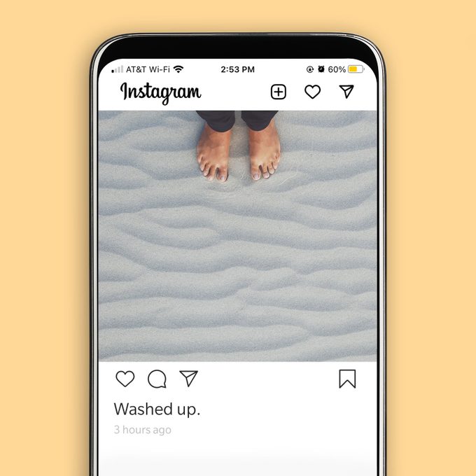 instagram screenshot displaying feet in sand with a funny beach caption
