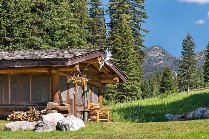 Lone Mountain Ranch In Big Sky Montana; cabin with mountains in the background