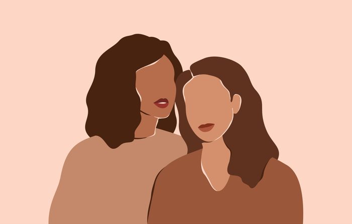 Two beautiful women with different skin colors stand together. Abstract minimal portrait of two girls in earth's natural tones. Concept of sisterhood and females friendship.