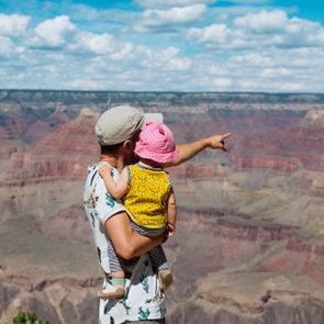USA, Arizona, Grand Canyon National Park, father and baby girl enjoying the view, rear view