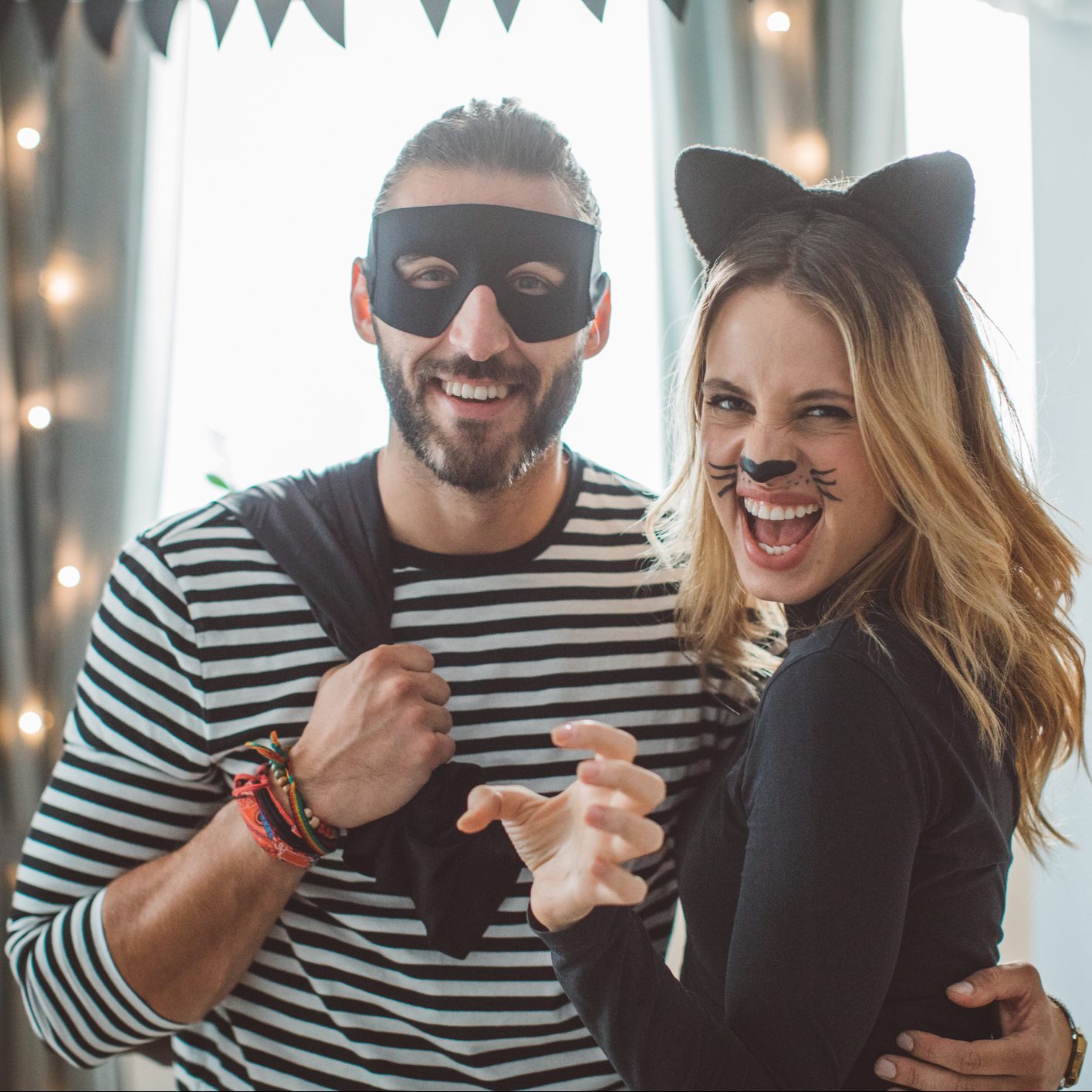 couple dressed in Cat burglar Halloween costume at a party
