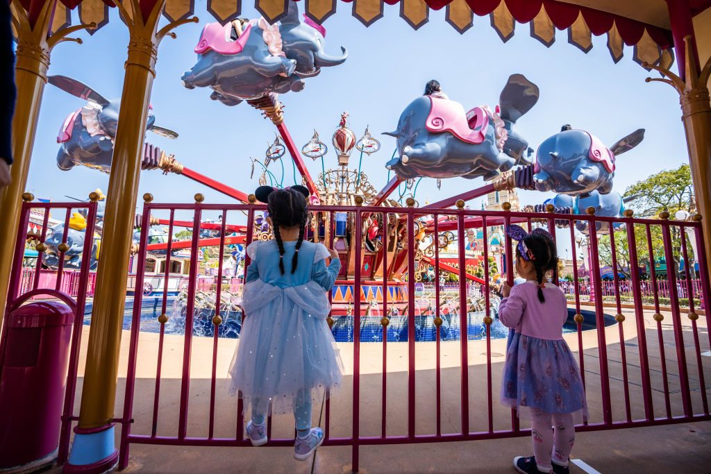 Two young girls line up for the ride of Dumbo the Flying...