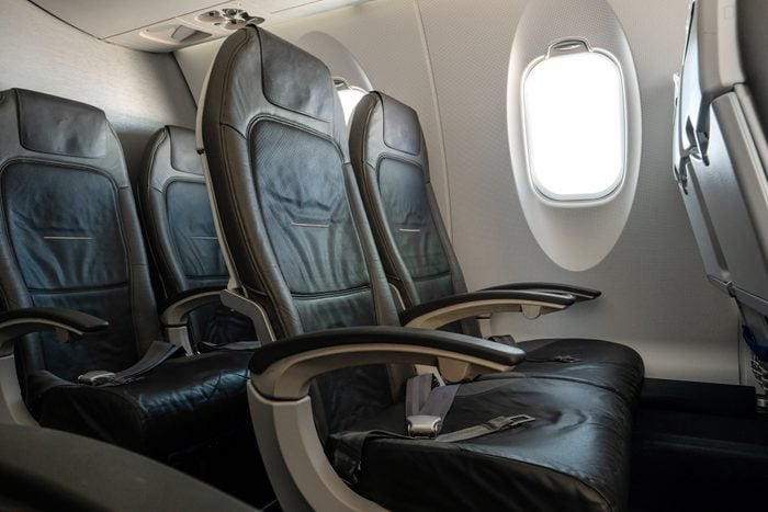 Empty airplane seats in second class on an international flight during August peak season