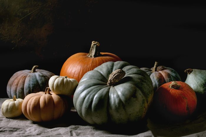 group of colorful pumpkins on dark background