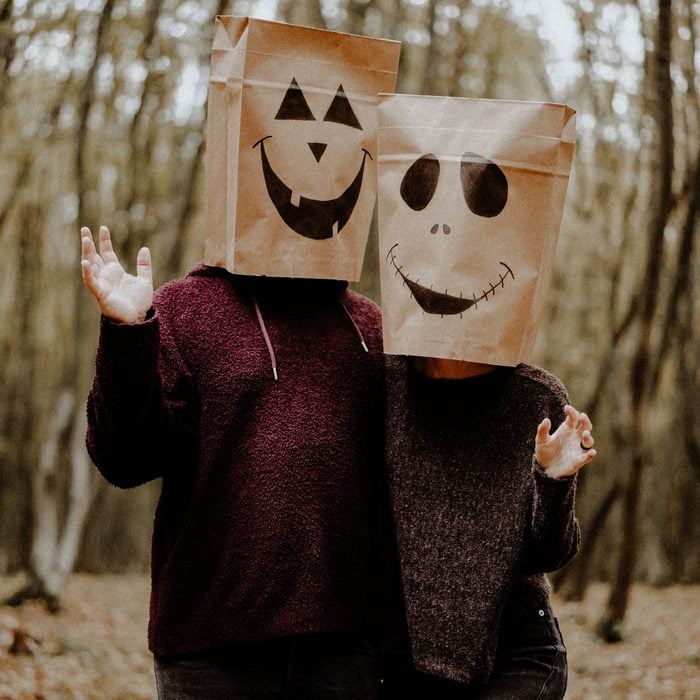 two people wearing Paper bag jack-o-lantern Halloween costume