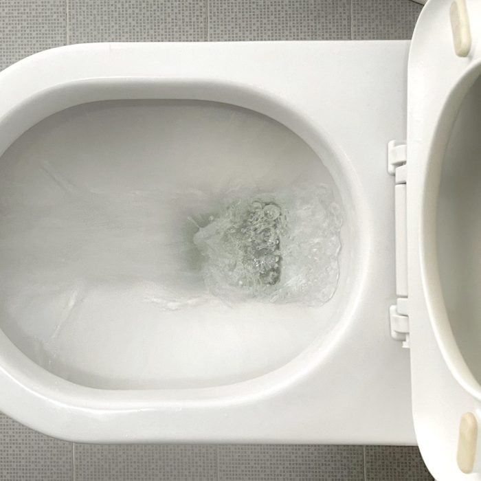 Water flushes down toilet bowl
