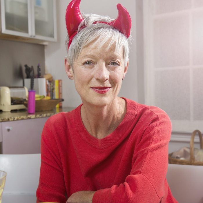 Senior woman dressed up as devil for halloween