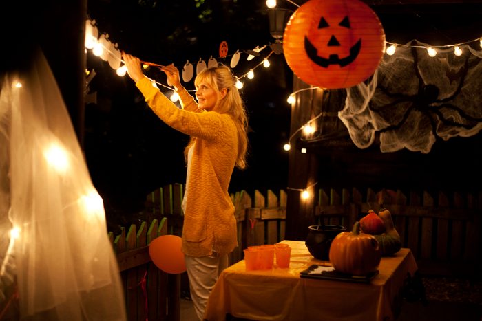 woman decorating house for halloween party