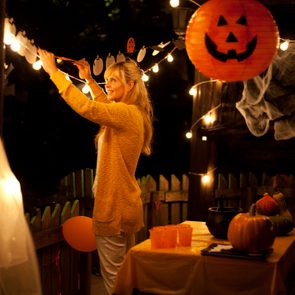 woman decorating house for halloween party