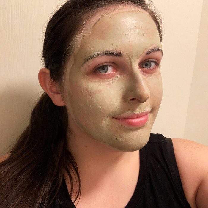 Selfie of Kelly Kuehn with aztec clay mask on face
