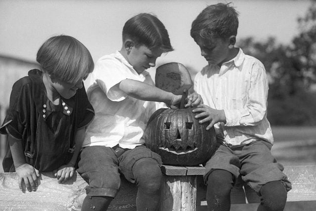 Children carving Jack O'lantern