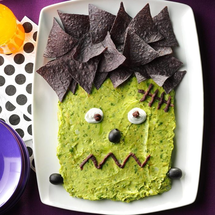 Frankenguac; guacamole and chips arranged to look like frankenstein's face for a halloween party dip idea