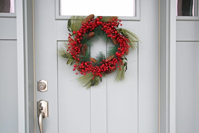 red berry wreath on front door of house