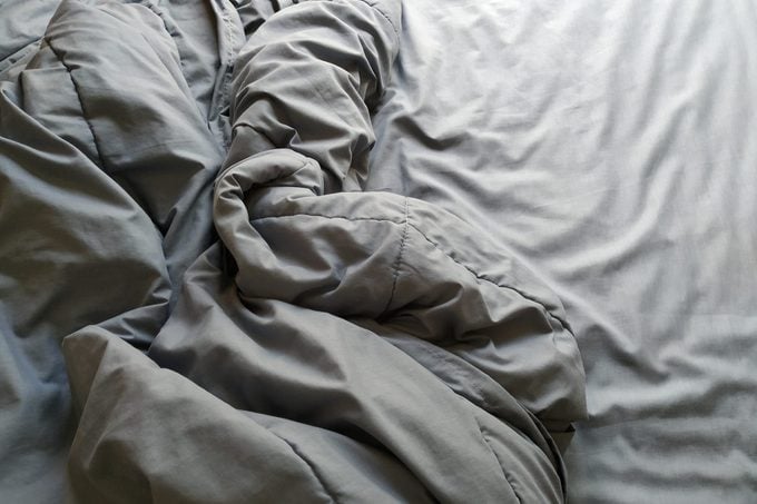 High Angle View Of Crumpled Blanket On Bed At Home