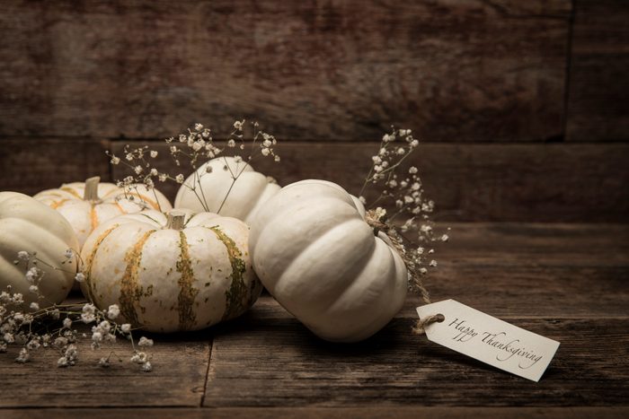 Autumn White Small pumpkins with card on wood background