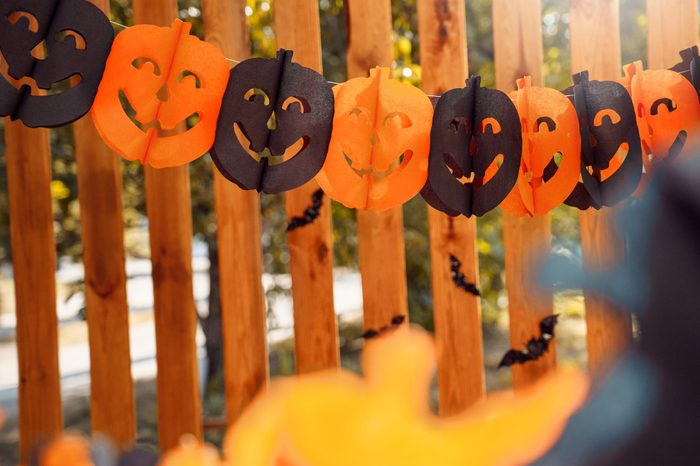 Paper garland decoration for halloween on wooden fence