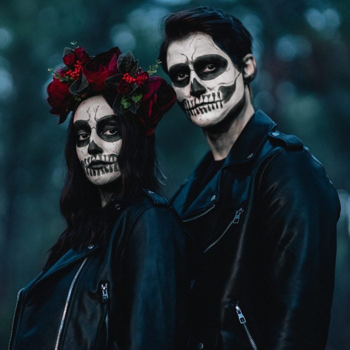 couple wearing day of the dead halloween costume
