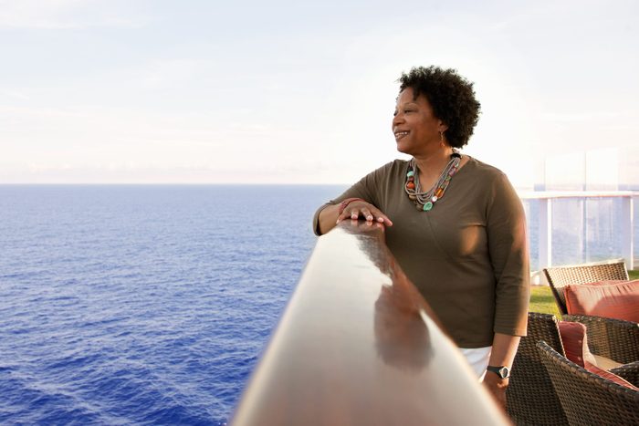Woman on cruise ship deck looking into the ocean