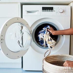 woman taking clothing out of a washing machine