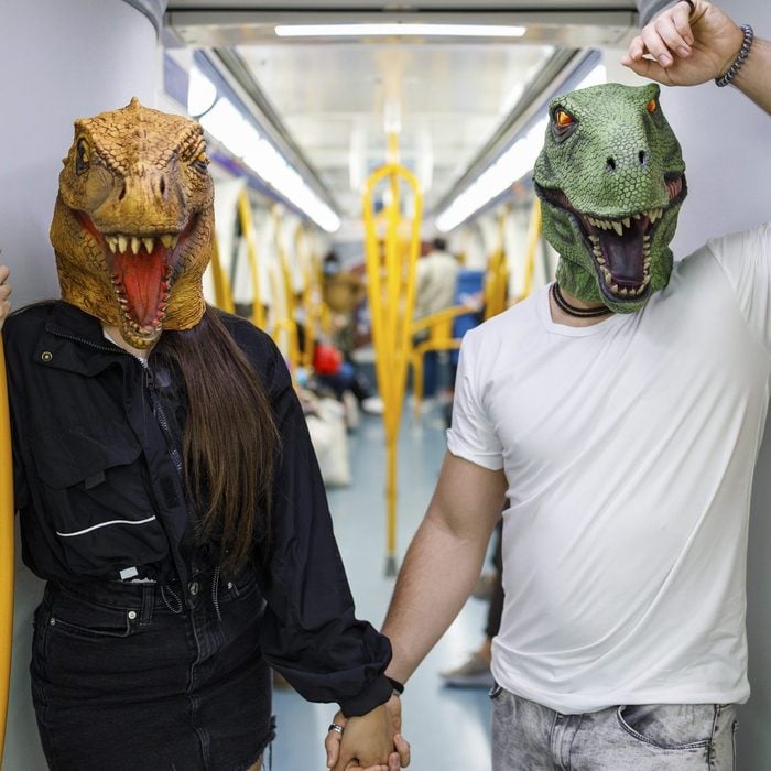 couple dressed as dinosaurs from jurassic park for halloween