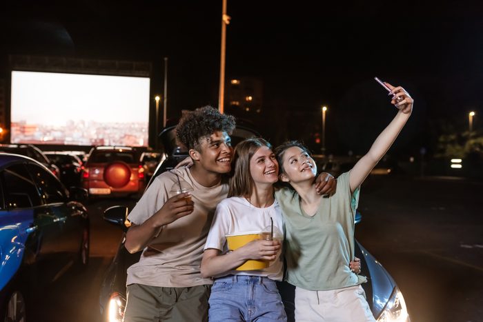 teenagers taking a selfie while at a drive in movie
