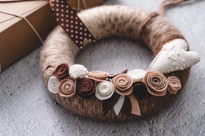 Close up on homemade yarn wreath DIY wool decoration hobby craft