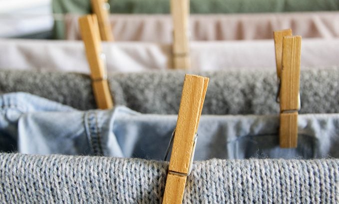 close up of laundry on a drying rack with clothes pins