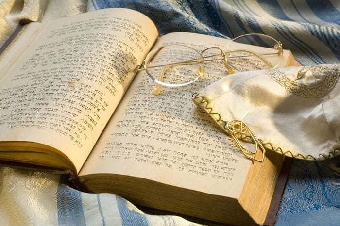 Jewish religious items: Sidur, book of prayer, Tallit, prayer shawls, book marker clip and Kippah skull cap.