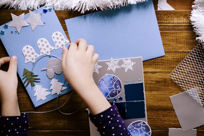 Little girl making homemade Christmas cards