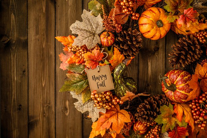 Ornate fall wreath with pumpkins, pinecones, message and leaves