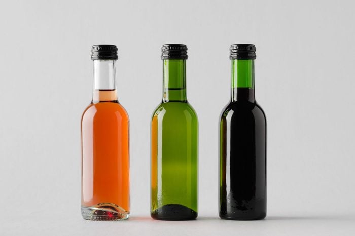 small bottles of wine on gray background