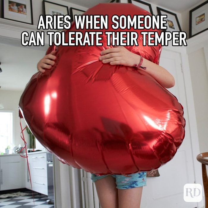 Aries When Someone Can Tolerate Their Temper meme text on image of person squeezing a giant heart shaped balloon