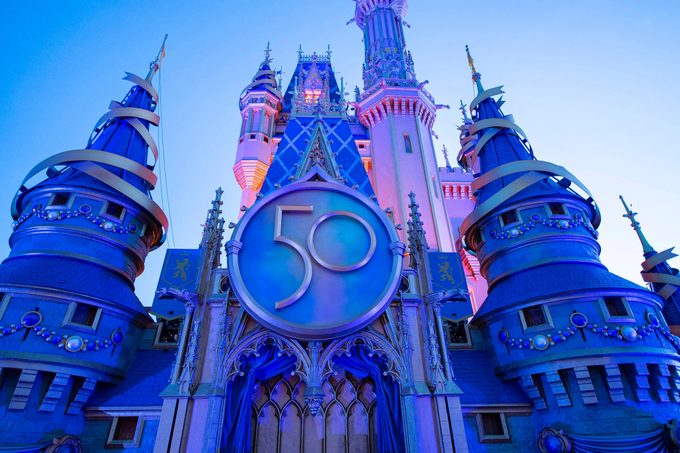 A new crest honoring the 50th anniversary of Walt Disney World Resort adorns Cinderella Castle at Magic Kingdom Park in Lake Buena Vista, Fla.