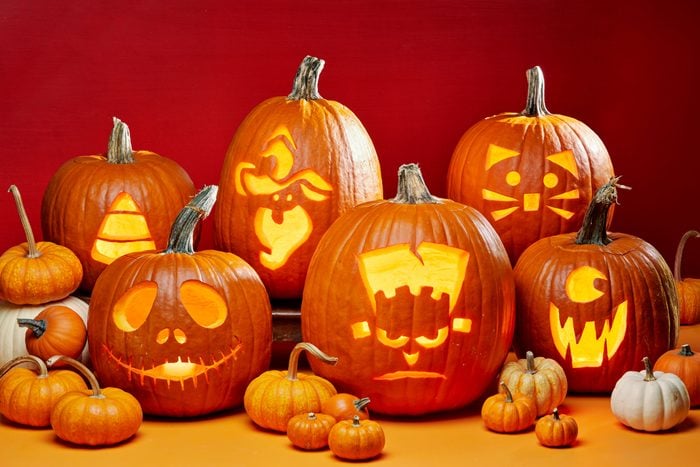 group of Halloween Jack O Lanterns Carved From Printable Templates; orange background