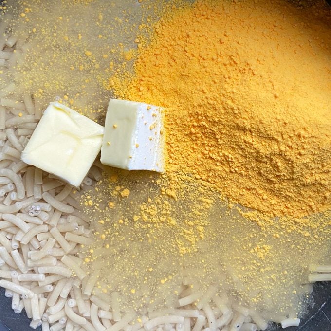 close up of Mac And Cheese Ingredients in a pot before stirring together