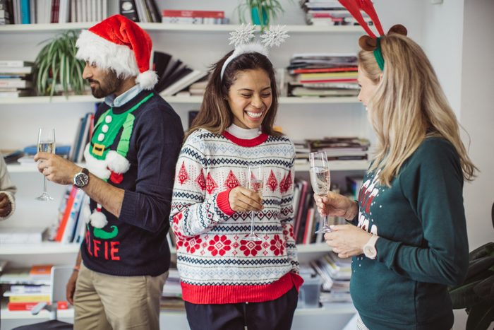three people talking at Ugly sweater party
