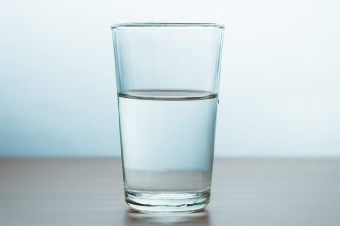 Glass Of Water On Table Against Wall