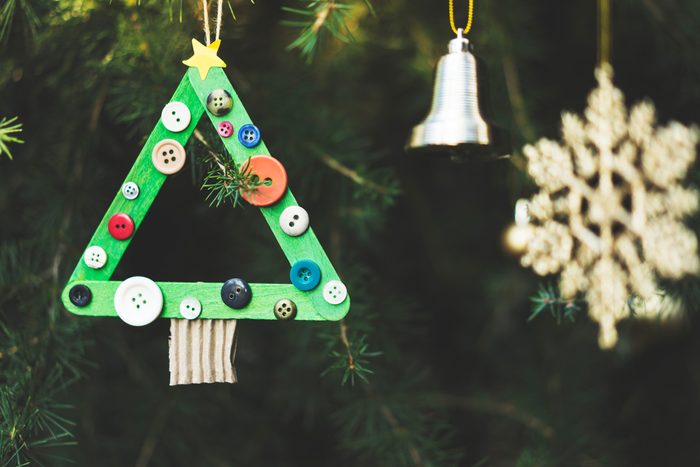 Homemade Christmas tree ornament made with ice cream sticks and buttons