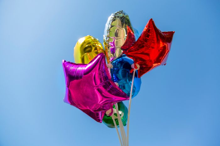 colorful helium balloons against blue sky