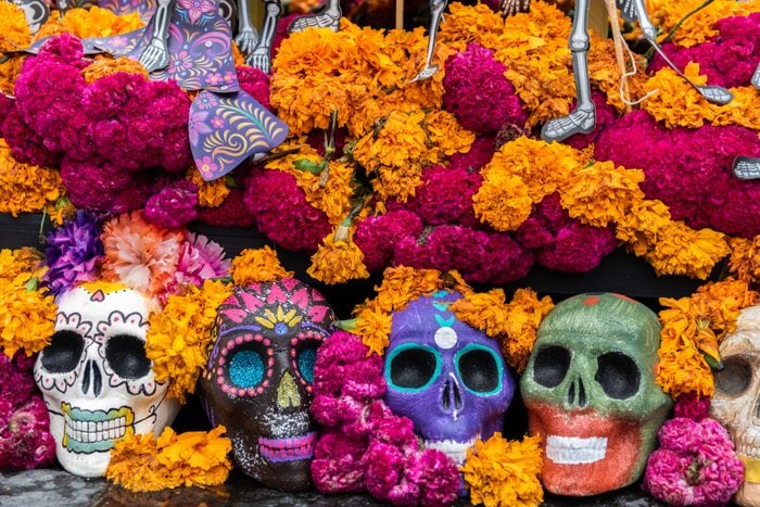 colorful flowers and skulls in celebration of day of the dead